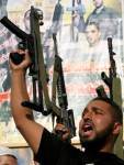 an al-Aqsa Martyrs’ Brigade militiaman holding aloft a H&K MP5 submachine gun