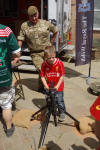 another small child encouraged to play with weaponry