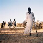 A disabled Sudanese refugee who fled an attack on his village in Darfur ©AI