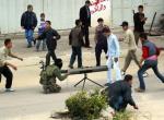 Hamas terrorists deploy a mortar while youths provide cover
