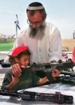 Kid learning from Jewish settlers how to shoot a UZI...
