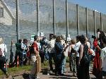 Protestors banging on outer fence.