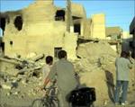 Samarra 2004. Iraqis look at a destroyed house. Photo Al Jazeera.