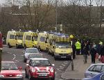Yellow Surveilance vans with camers on top and full of police in riot gear