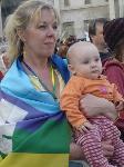 A mother and child draped in a peace flag in Trafalgar Square