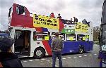 the open-top double-decker bus lead the protest motorcade