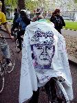 A cycling Brian Haw supporter wears her banner like a cape ...