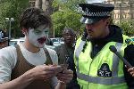 Clown reads Policeman his rights.