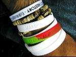 White Make Poverty wrist bands with a new Respect wrist band