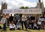 Protestors assemble with banner