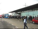 scores of arms fair delegates waiting for replacement buses