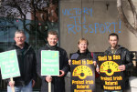 Lefties holding placards - graffiti in background