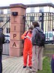 Protestor in Guantanmo orange at back gates of LIPA