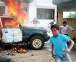 Protesters torch a government vehicle in Patan