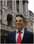 Man warning a mask of George Bush standing in front of Bank of England