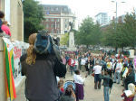 Local news crews cover the demo
