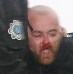 Beaten protestor being dragged by police to be thrown into ditch