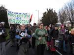 The crowd march down the main road before people disperse in time for 2pm visits