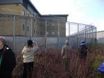 Making contact - waving to asylum seeker(s) at back of detention centre