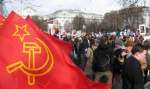 Red flags flutter while the protesters gather at Hyde Park's Speakers Corner