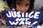 A Filipino child holds a placard during a rally against police brutalities