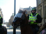 Mounted police push protestors further down the street away from Weatherspoons