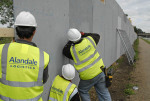 Workers erecting hordings which will surround the Olympic construction site