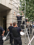 Police build a scaffold to get roof protesters
