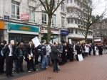 a minute's silence for the church's victims, with heads down and masks off