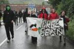 Protesters walk down the street with their Free Sean banner