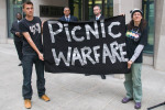 Picnic Warfare banner and security men at Ministry of Justice