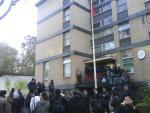 Greek embassy, red-black flag rising