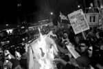 Demonstrators burn an Israeli flag outside the embassy. 2009