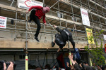 People coming down after hanging a banner against the arms trade