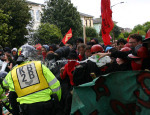 Water being thrown at Police as they try to rip away the banners