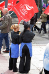Two waitress' take a break to watch the march pass down Broad St