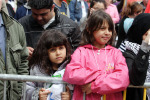 Two wee girls looking over the crush barriers at rally