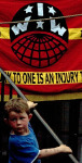 Young lad in front of IWW banner