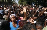 Haitians march on site of visit by former U.S. President Clinton