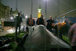Setting up Tents as Bailiffs look on.