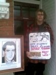 Ciaron O'Reilly with 'Write to Bradley Manning Placard' and Photo of Giuseppe Co