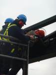 Garda angle-grinding D-lock millimeters from a protestors head