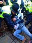 Being manhandled by police, but luckily he managed to wriggle free!