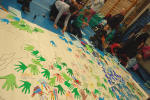 2012: children working on Hands Up for Peace map of the world