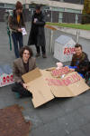 Tristan joins the protest outside (under the cardboard, left)