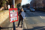 Vigil on Grosvenor Rd, periodically crossing with coffin at pedestrian lights