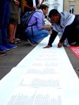 Assembling the names of the dead.