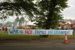 Banner on the fence and peace flag in background on the main gate