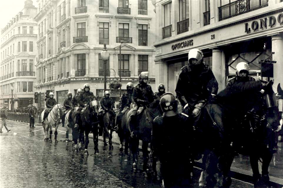 Line of police officers on horses