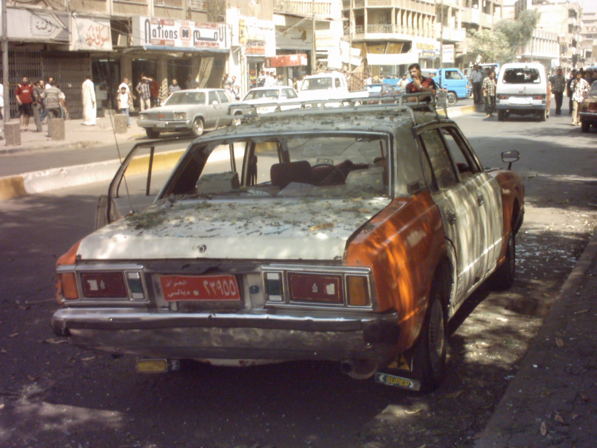 Smashed up taxi at bomb site.